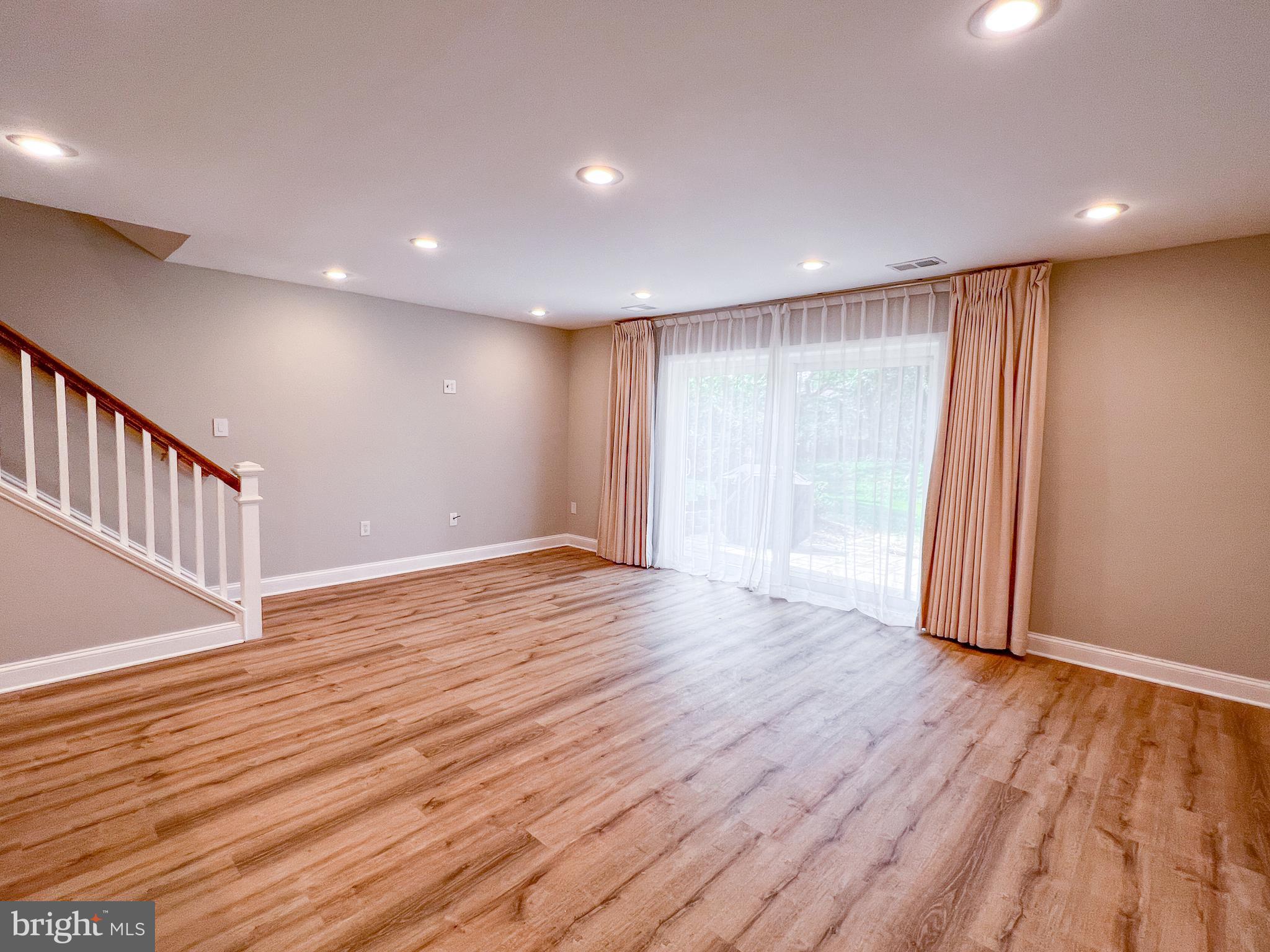 36 Pennydog Court Silver Spring, MD 20902 - Photo 18 of 27 a view of an empty room with wooden floor and staircase