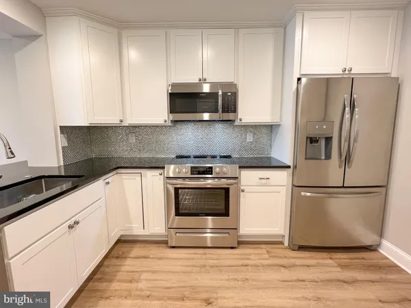 a kitchen with cabinets and stainless steel appliances