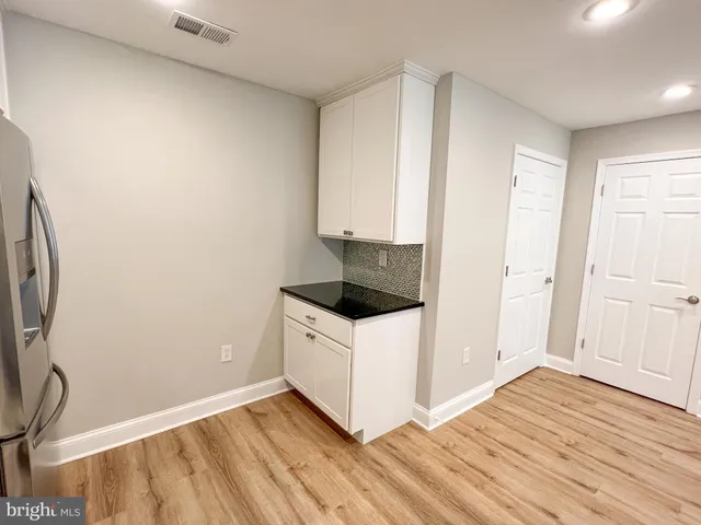 a kitchen with a sink and a stove top oven
