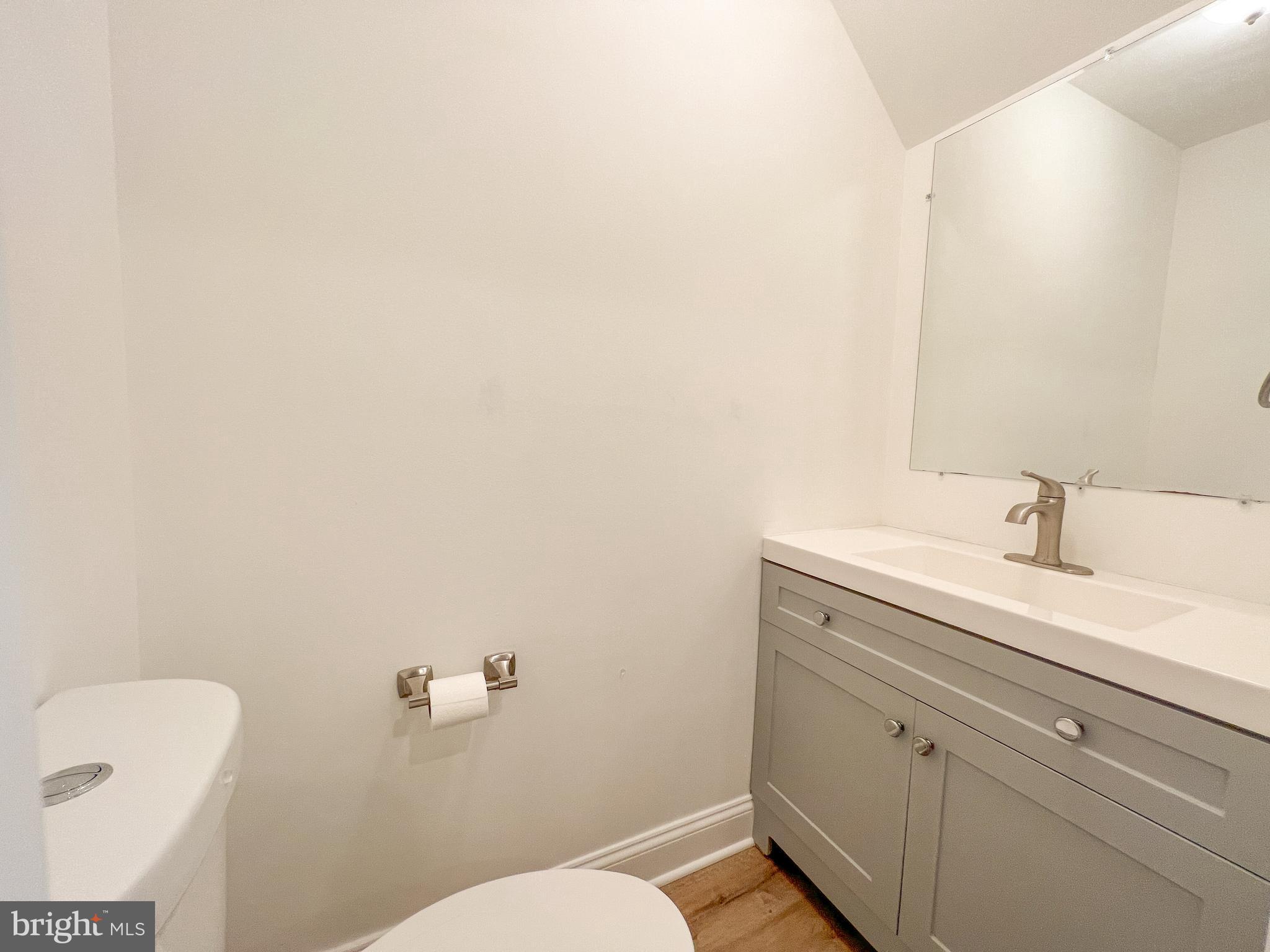 36 Pennydog Court Silver Spring, MD 20902 - Photo 26 of 27 a bathroom with a sink a toilet and a mirror