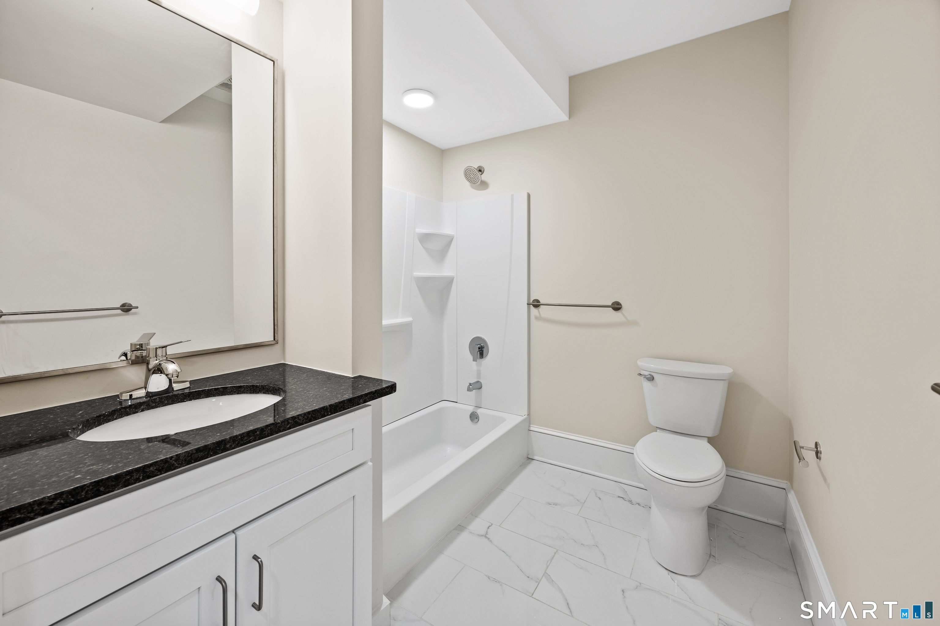 1355 Main Street, Unit 405 Hartford, CT 06103 - Photo 7 of 11 a bathroom with a granite countertop sink toilet and shower