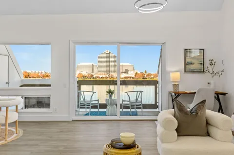 a living room with furniture and a floor to ceiling window