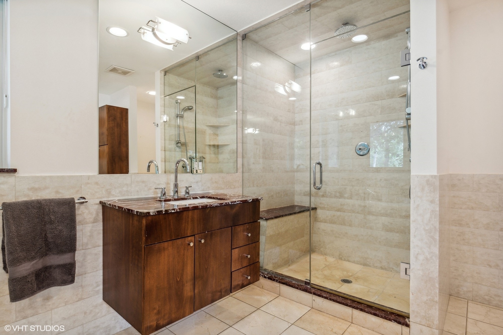 2921 Sheridan Road Evanston, IL 60201 - Photo 21 of 38 a bathroom with a granite countertop sink a shower and a mirror
