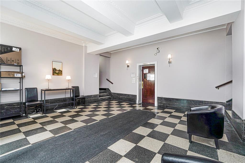 9524 Fort Hamilton Parkway, Unit 601 Brooklyn, NY 11209 - Photo 2 of 13 a living room with a couch and a rug