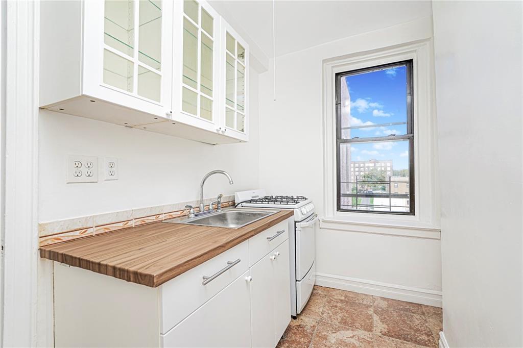 9524 Fort Hamilton Parkway, Unit 601 Brooklyn, NY 11209 - Photo 6 of 13 a kitchen with a stove and a window