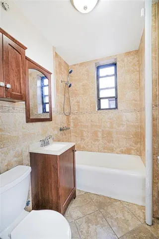 a bathroom with a toilet a sink and bathtub