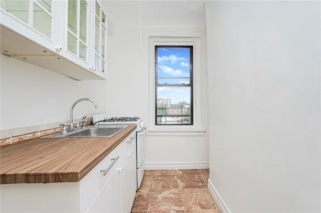 a view of a kitchen with a sink and cabinets