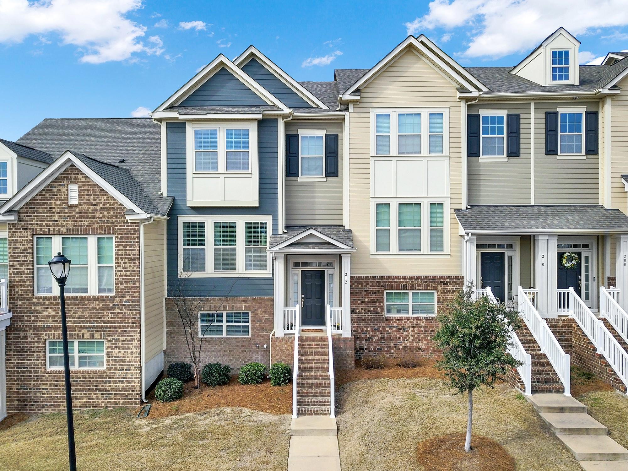 212 Butterfly Place Tega Cay, SC 29708 - Photo 1 of 35 a front view of a house with garden