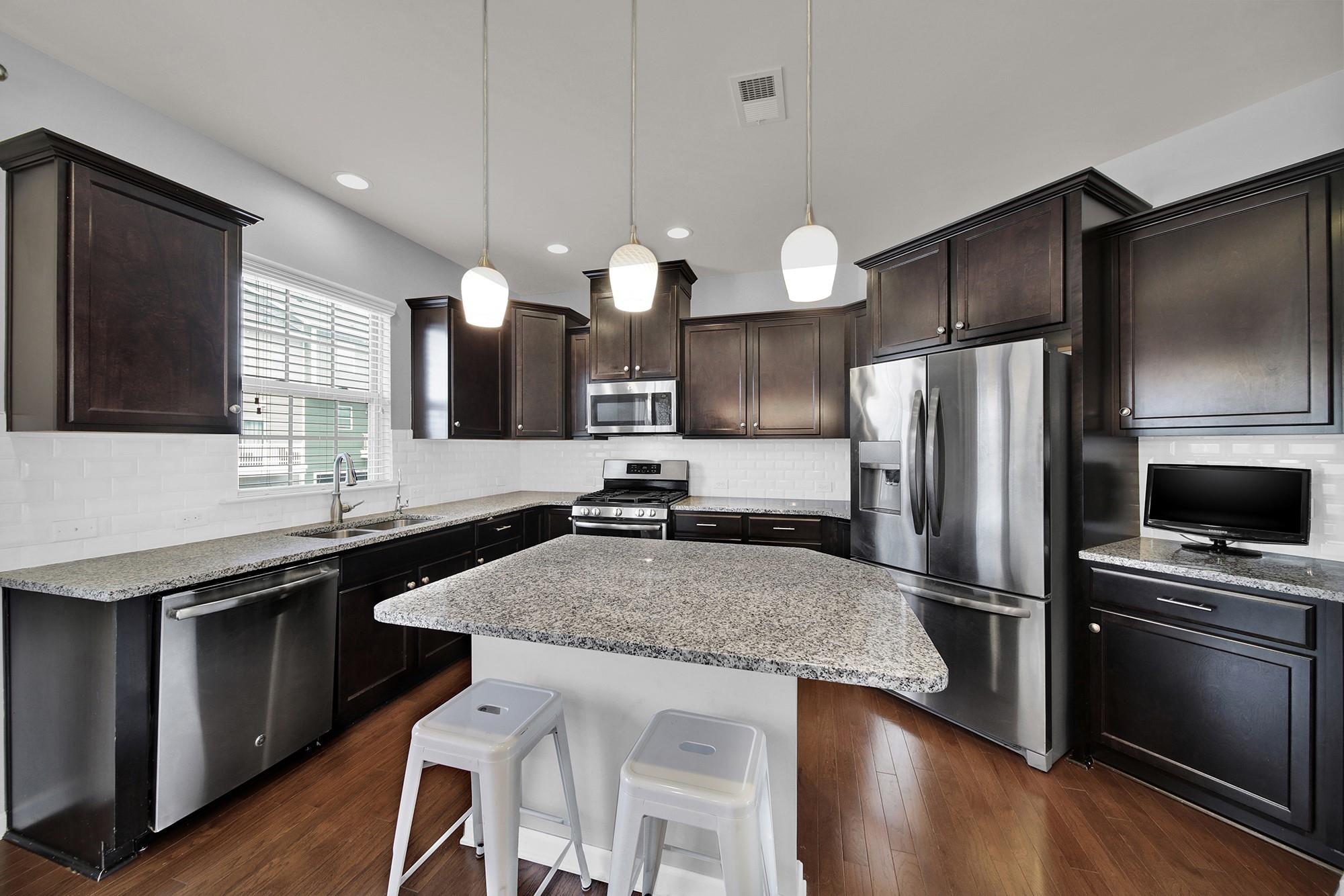 212 Butterfly Place Tega Cay, SC 29708 - Photo 12 of 35 a kitchen with a center island and stainless steel appliances