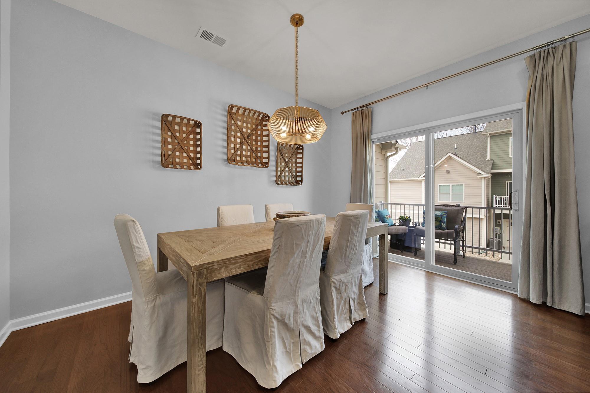 212 Butterfly Place Tega Cay, SC 29708 - Photo 13 of 35 a view of a dining room with furniture wooden floor and chandelier