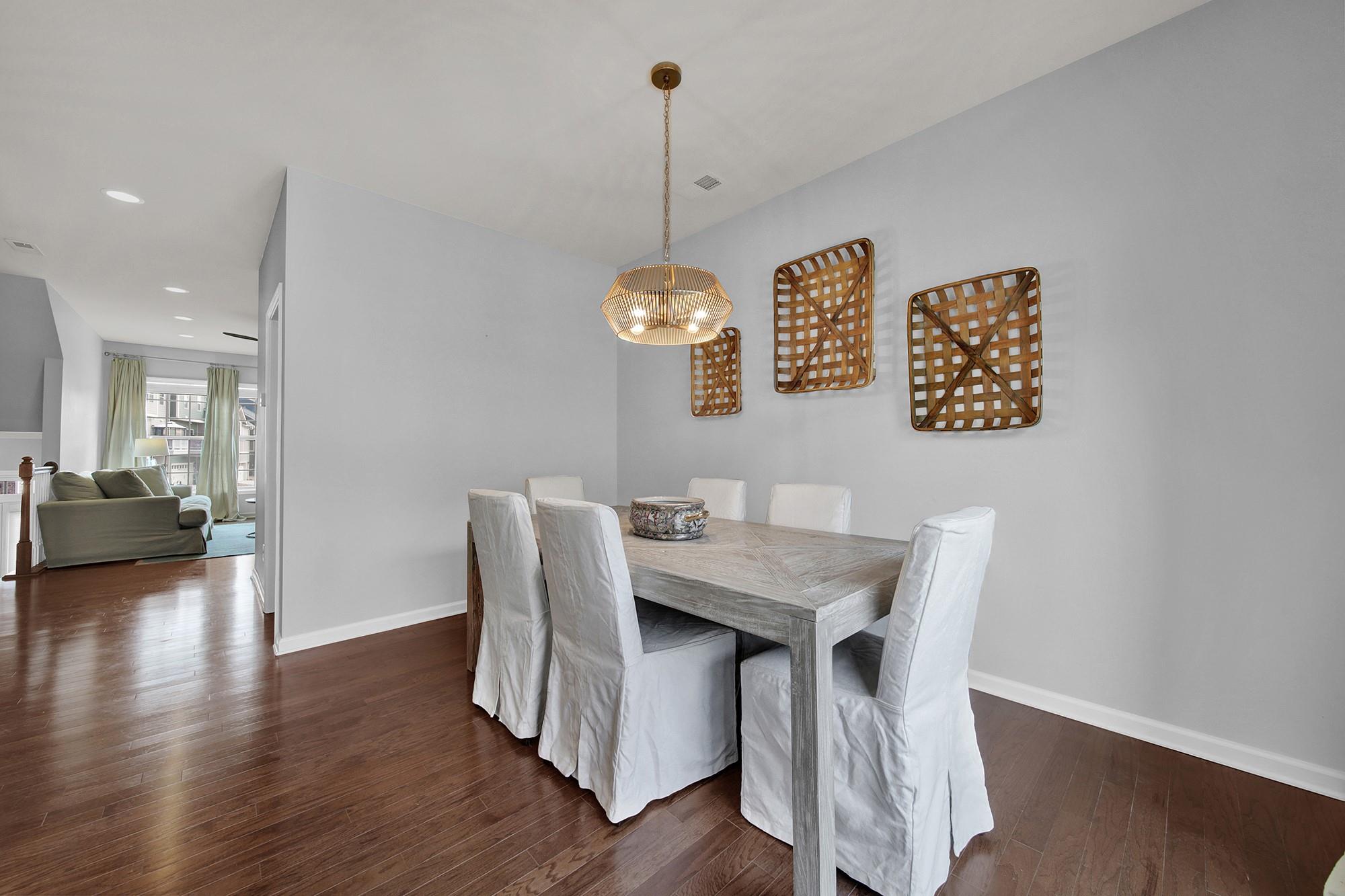 212 Butterfly Place Tega Cay, SC 29708 - Photo 14 of 35 a view of a dining room with furniture wooden floor and a chandelier