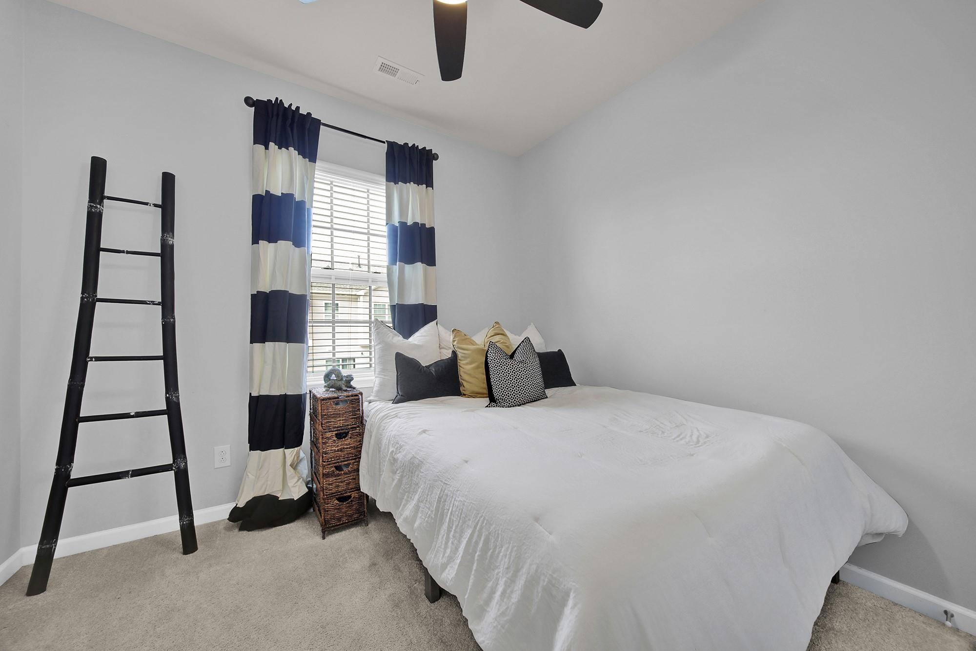 212 Butterfly Place Tega Cay, SC 29708 - Photo 24 of 35 a bedroom with a bed and a window