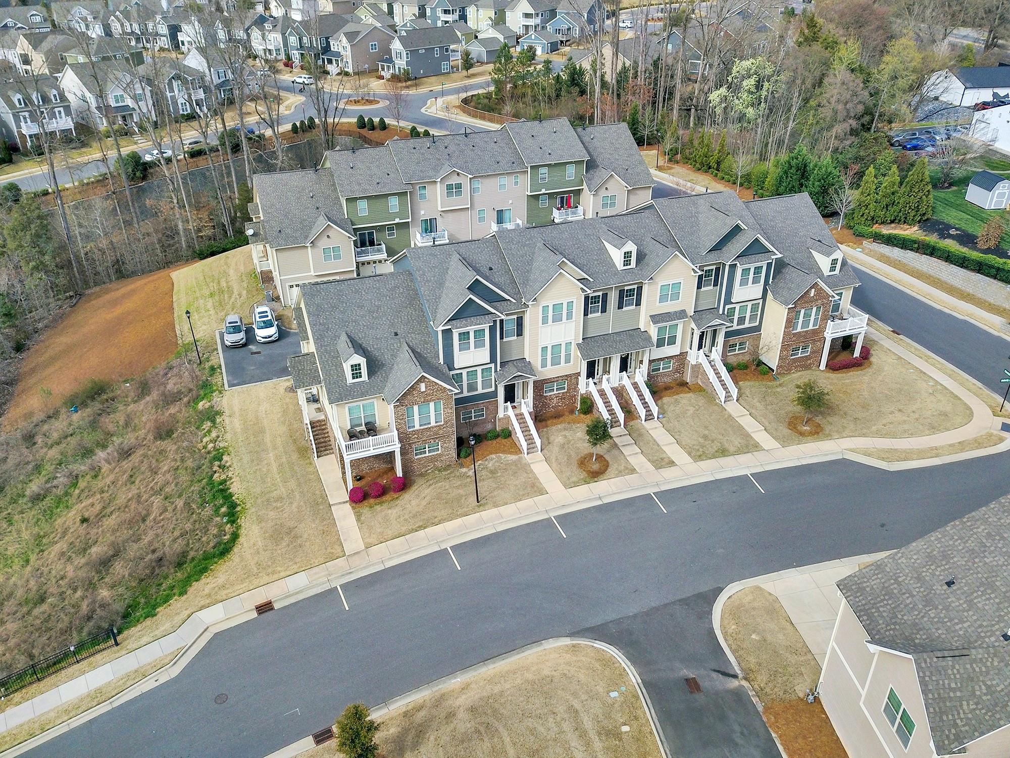 212 Butterfly Place Tega Cay, SC 29708 - Photo 28 of 35 an aerial view of a house with swimming pool and large trees