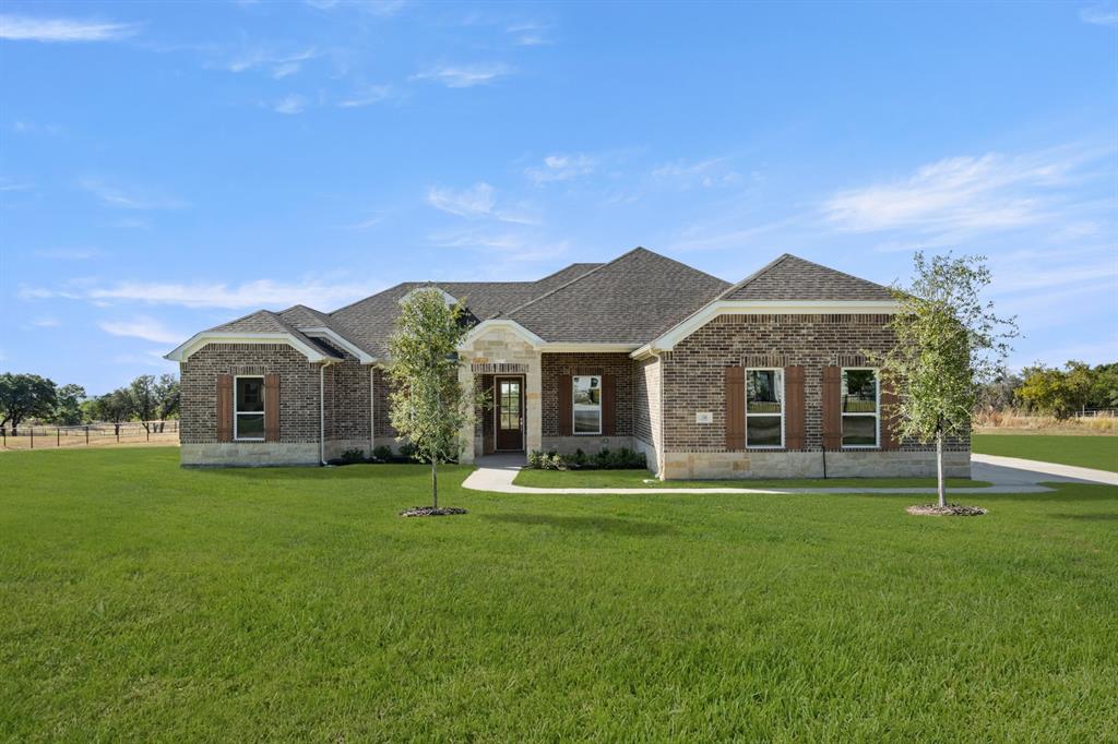 a front view of a house with a yard