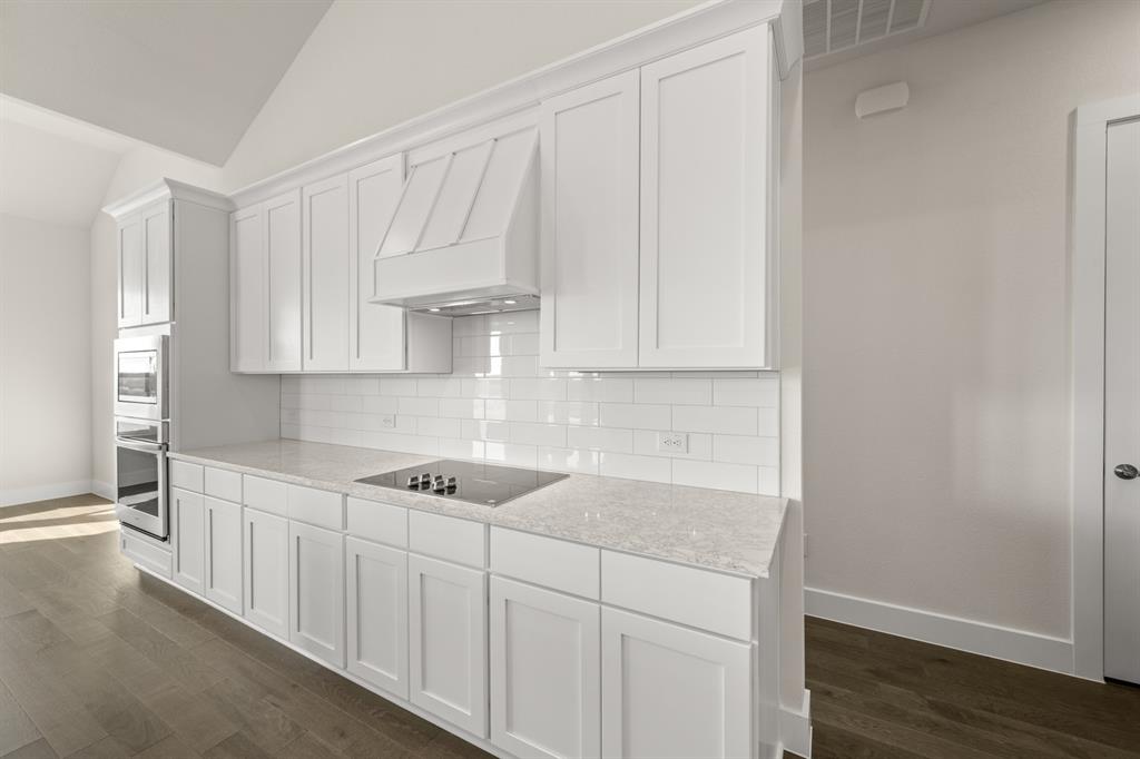 1300 Green Ridge Drive Weatherford, TX 76085 - Photo 11 of 24 a kitchen with white cabinets and sink