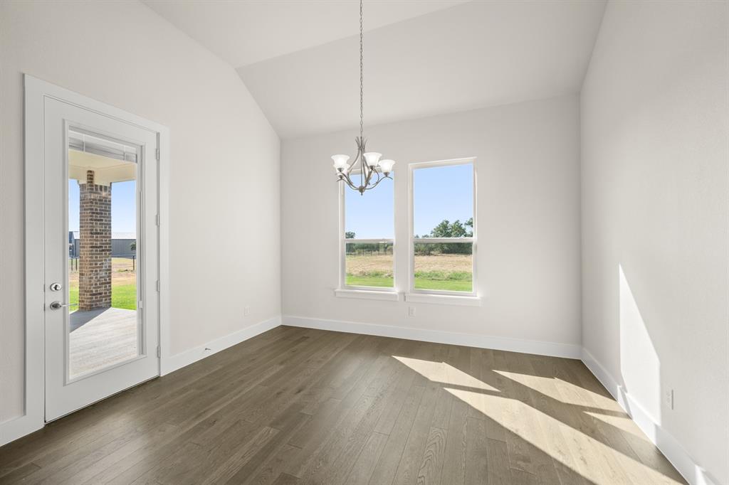 1300 Green Ridge Drive Weatherford, TX 76085 - Photo 12 of 24 a view of an empty room with wooden floor and a window