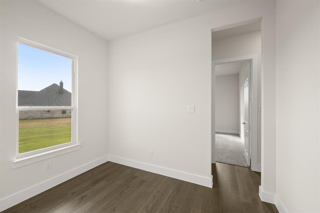 1300 Green Ridge Drive Weatherford, TX 76085 - Photo 16 of 24 an empty room with wooden floor and a window