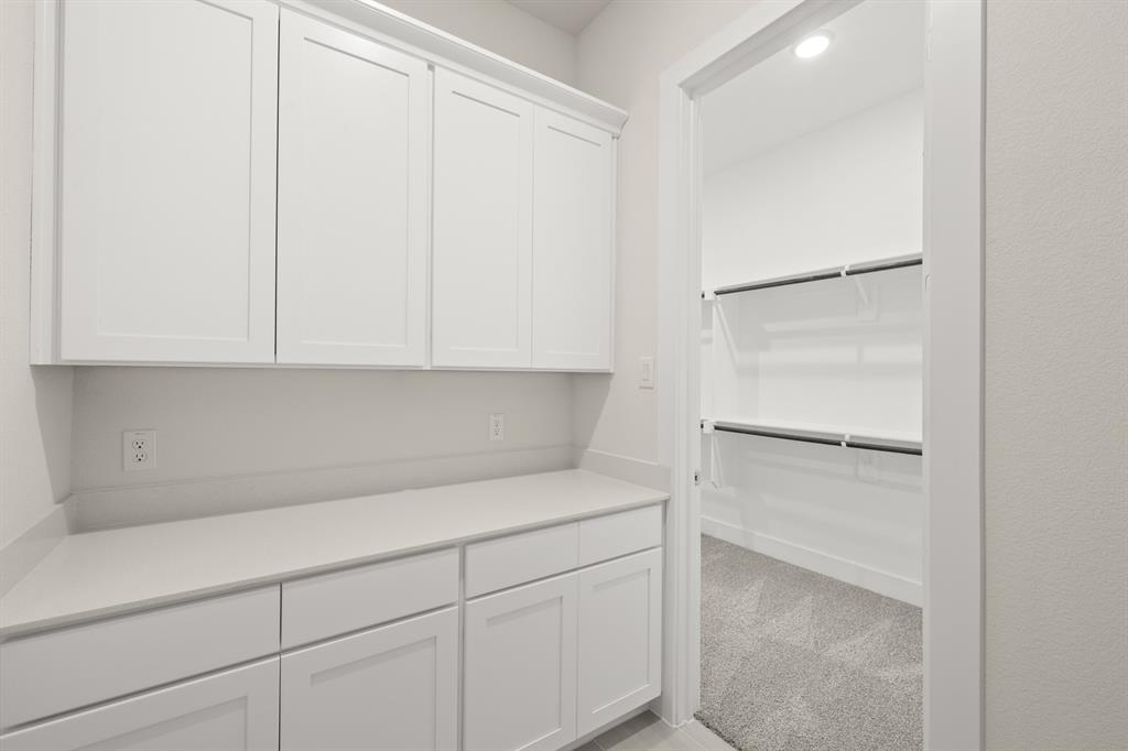 1300 Green Ridge Drive Weatherford, TX 76085 - Photo 18 of 24 a kitchen with a white cabinets and a refrigerator