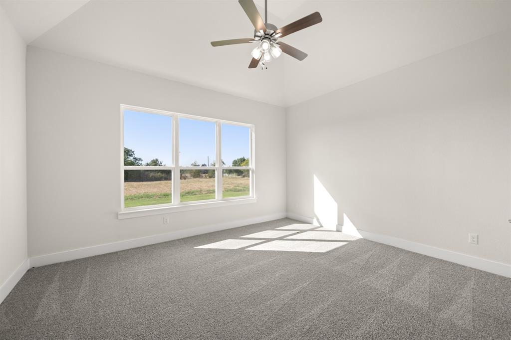 1300 Green Ridge Drive Weatherford, TX 76085 - Photo 19 of 24 a view of a livingroom with a window and a ceiling fan