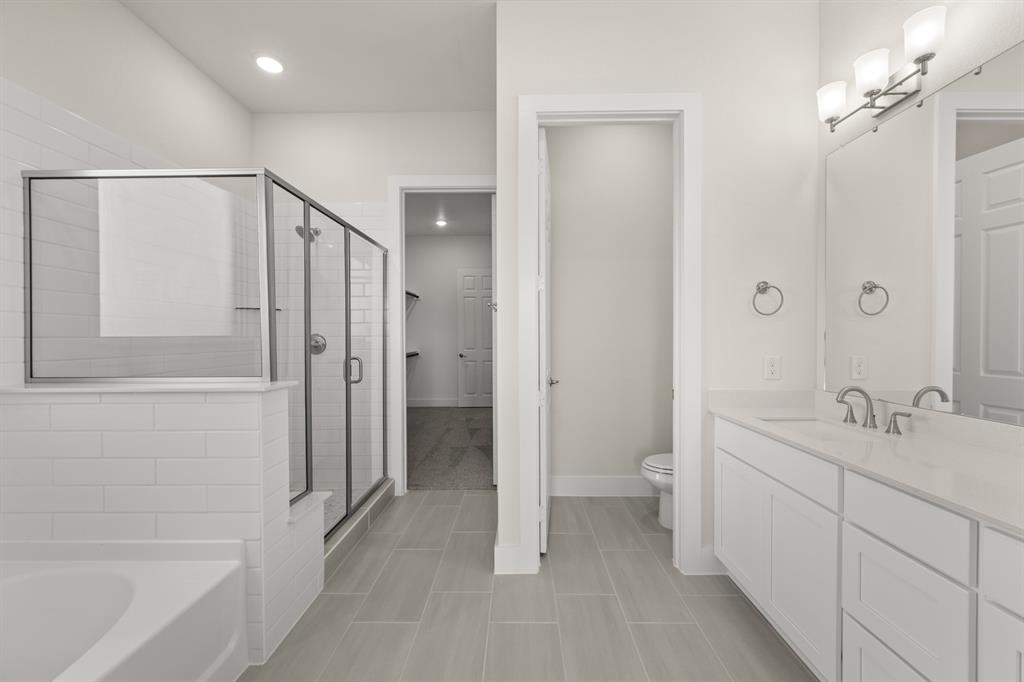 1300 Green Ridge Drive Weatherford, TX 76085 - Photo 21 of 24 a bathroom with a double vanity sink a toilet and shower