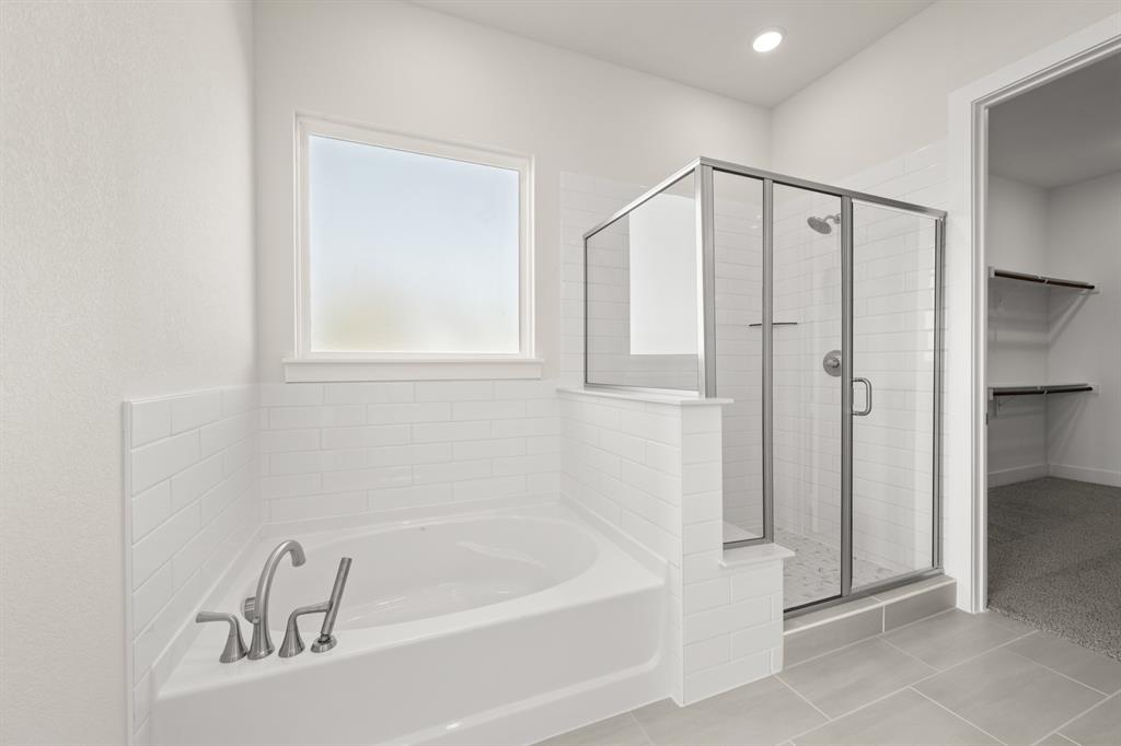 1300 Green Ridge Drive Weatherford, TX 76085 - Photo 22 of 24 a bathroom with a bathtub and a shower