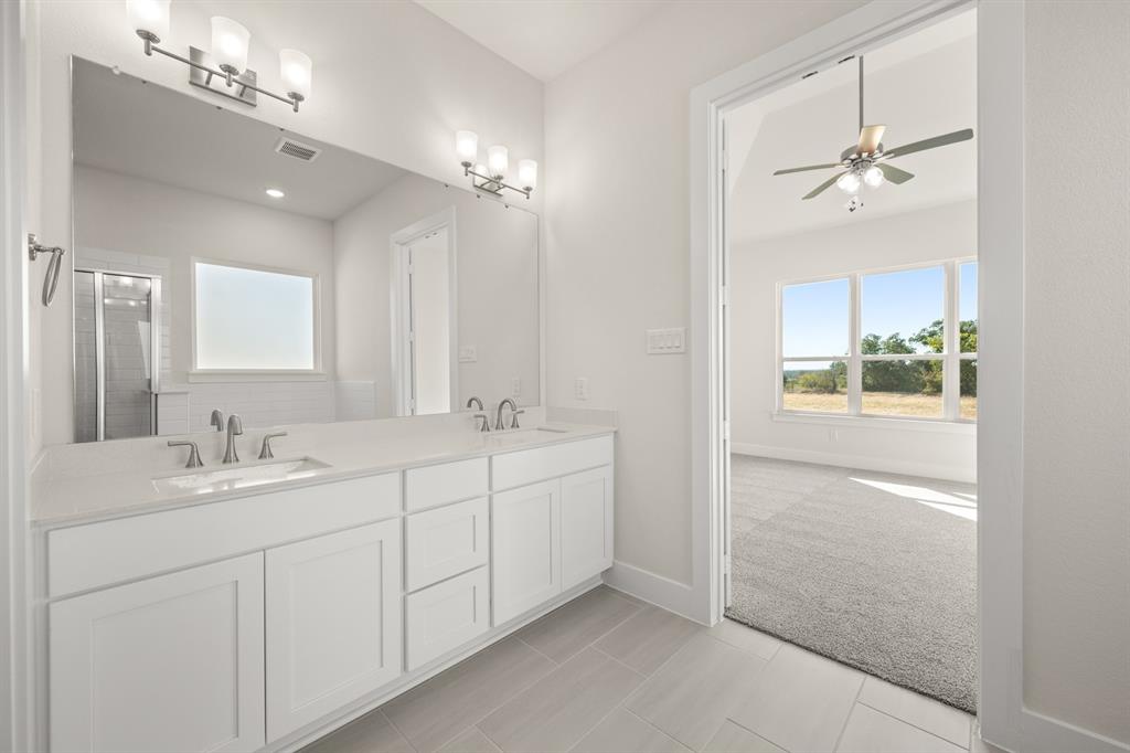 1300 Green Ridge Drive Weatherford, TX 76085 - Photo 23 of 24 a bathroom with a double vanity sink and mirror