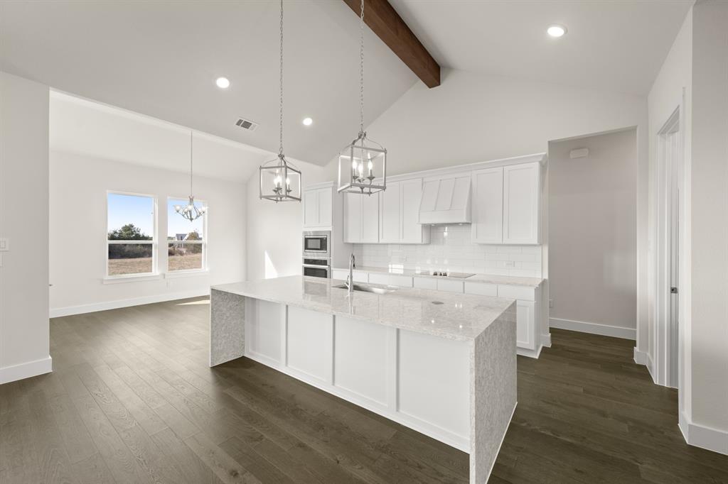 1300 Green Ridge Drive Weatherford, TX 76085 - Photo 7 of 24 a large kitchen with a lot of counter space and wooden floor