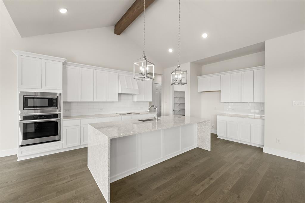 1300 Green Ridge Drive Weatherford, TX 76085 - Photo 9 of 24 a kitchen with white cabinets and stainless steel appliances