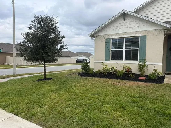 a front view of a house with a yard