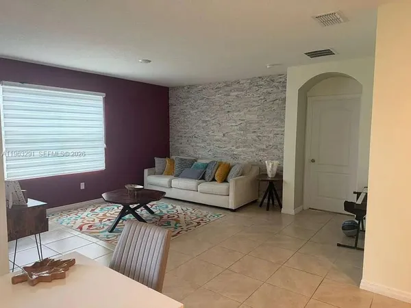 a living room with furniture and a window