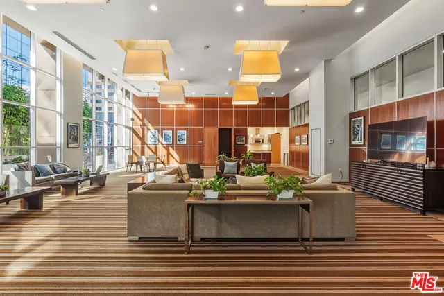 a view of living room with furniture and floor to ceiling windows