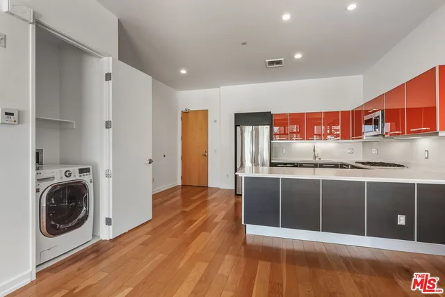 a view of a kitchen with stainless steel appliances granite countertop a refrigerator and a sink
