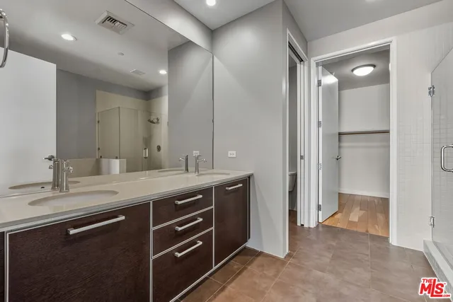 a bathroom with a granite countertop sink mirror and double