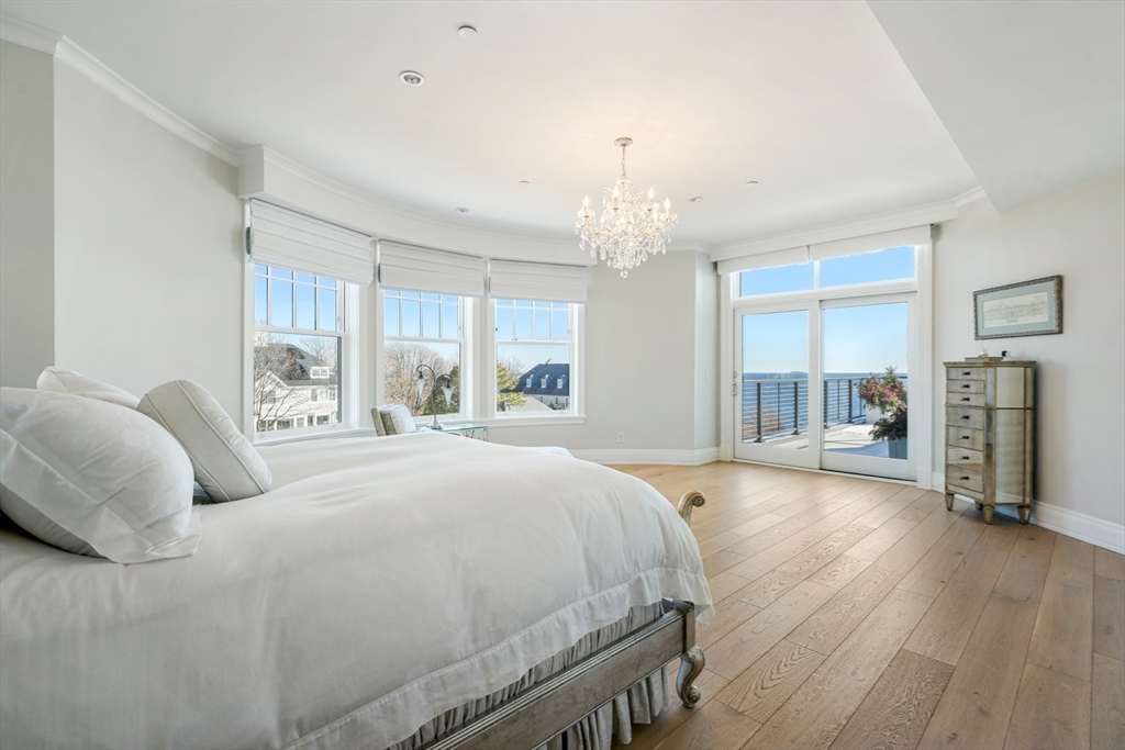 35 Littles Point Road, Unit S201 Swampscott, MA 01907 - Photo 14 of 36 a spacious bedroom with a bed chandelier and windows