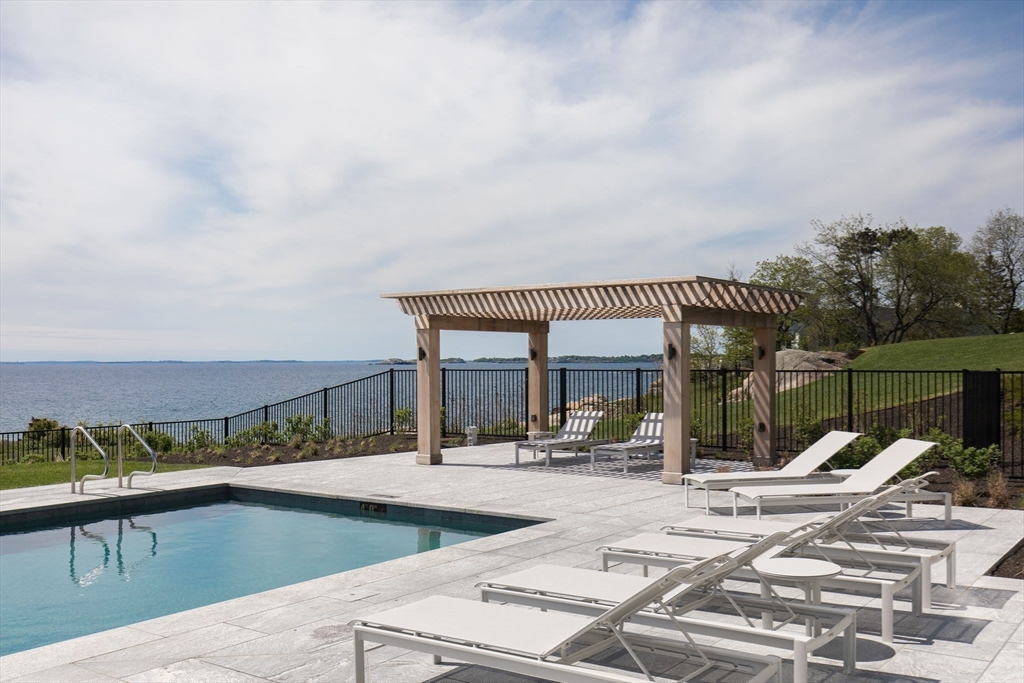 35 Littles Point Road, Unit S201 Swampscott, MA 01907 - Photo 26 of 36 a view of a swimming pool with a patio and a yard