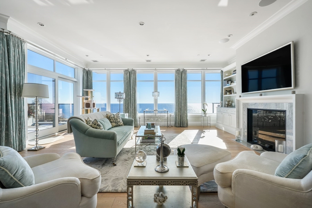 35 Littles Point Road, Unit S201 Swampscott, MA 01907 - Photo 3 of 36 a living room with fireplace furniture and a flat screen tv