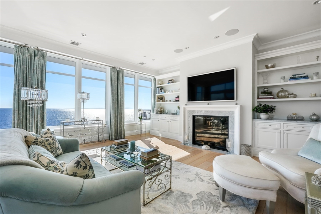 35 Littles Point Road, Unit S201 Swampscott, MA 01907 - Photo 5 of 36 a living room with furniture a fireplace and a flat screen tv