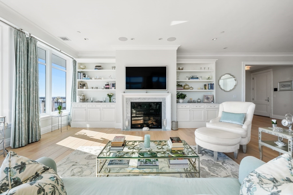 35 Littles Point Road, Unit S201 Swampscott, MA 01907 - Photo 6 of 36 a living room with furniture a flat screen tv and a fireplace