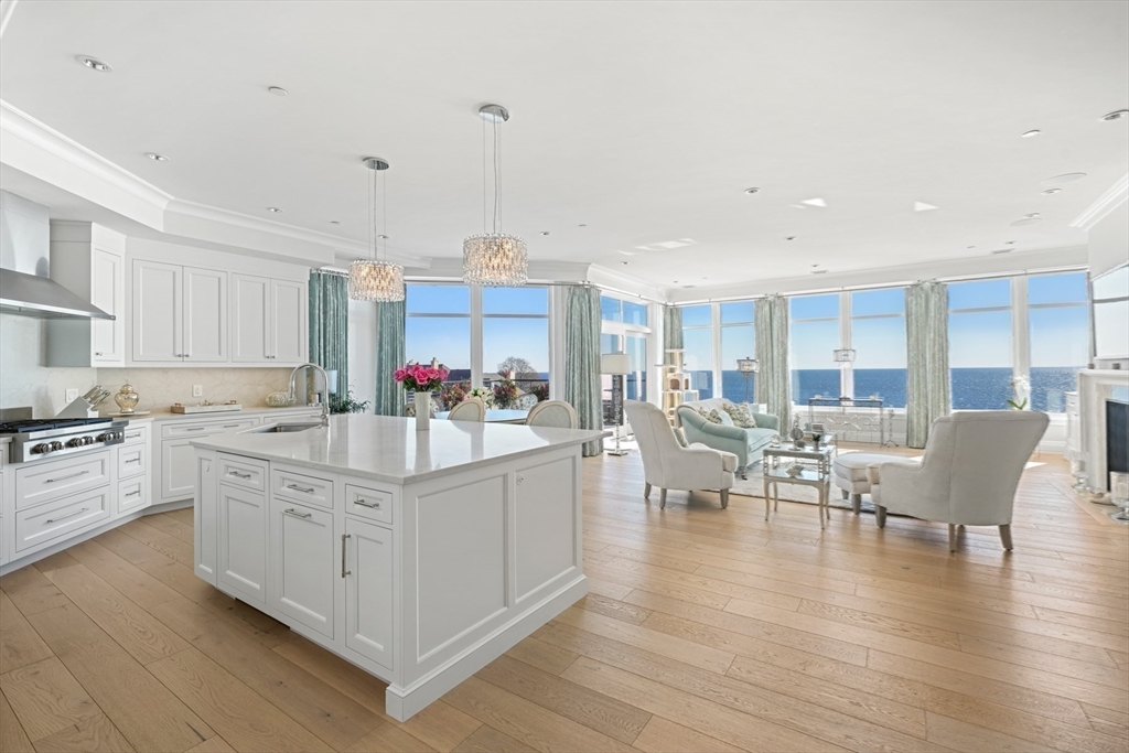35 Littles Point Road, Unit S201 Swampscott, MA 01907 - Photo 8 of 36 a kitchen with stainless steel appliances granite countertop a stove and white cabinets