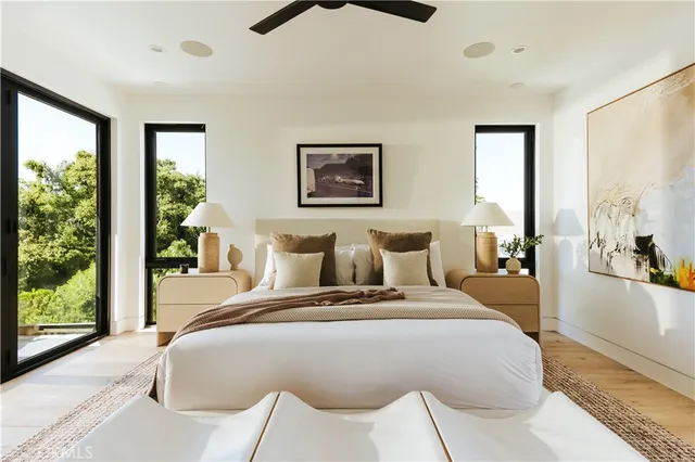 a bedroom with a large bed and a large window