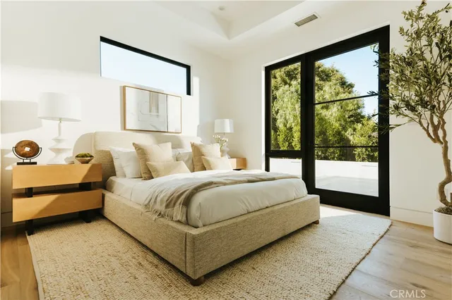 a bedroom with a bed and a large window