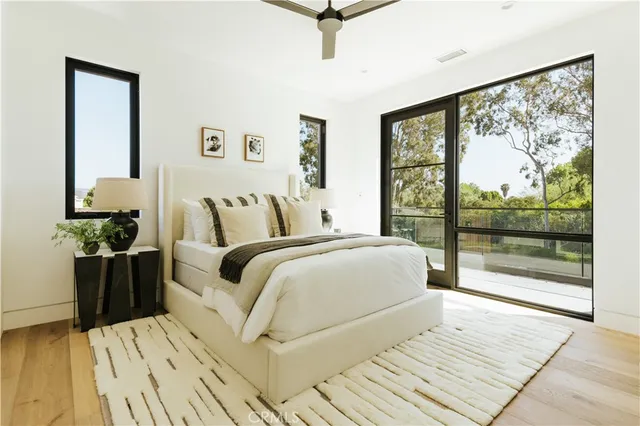 a bedroom with a large bed and a large window