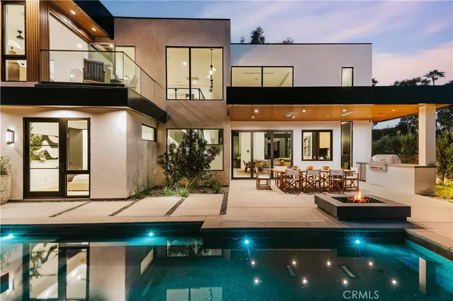 a view of house with a swimming pool outdoor seating