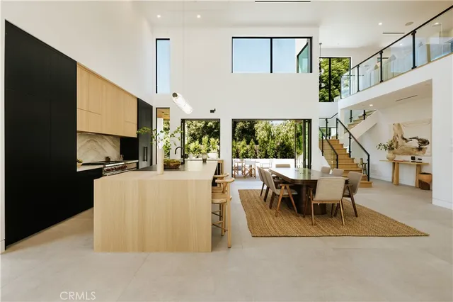 a living room with furniture a table and a large window