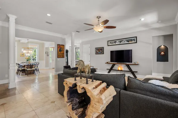 a kitchen with stainless steel appliances granite countertop a sink a stove a dining table and chairs