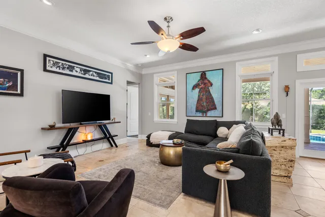 a front view of a house with a garden and trees