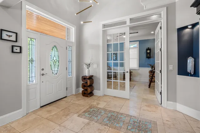 a view of a dining room with furniture and chandelier