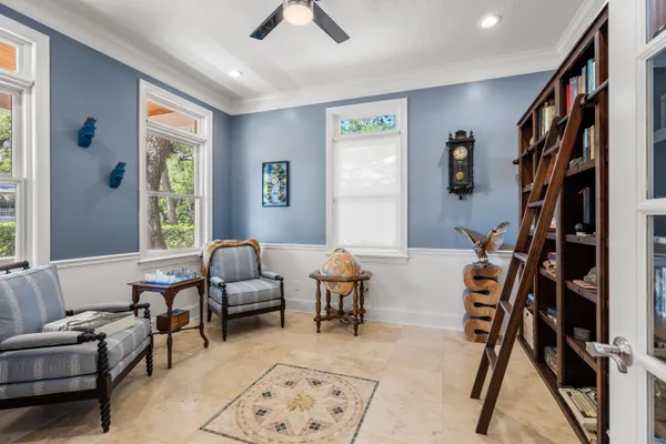 a living room with furniture potted plant and a chandelier