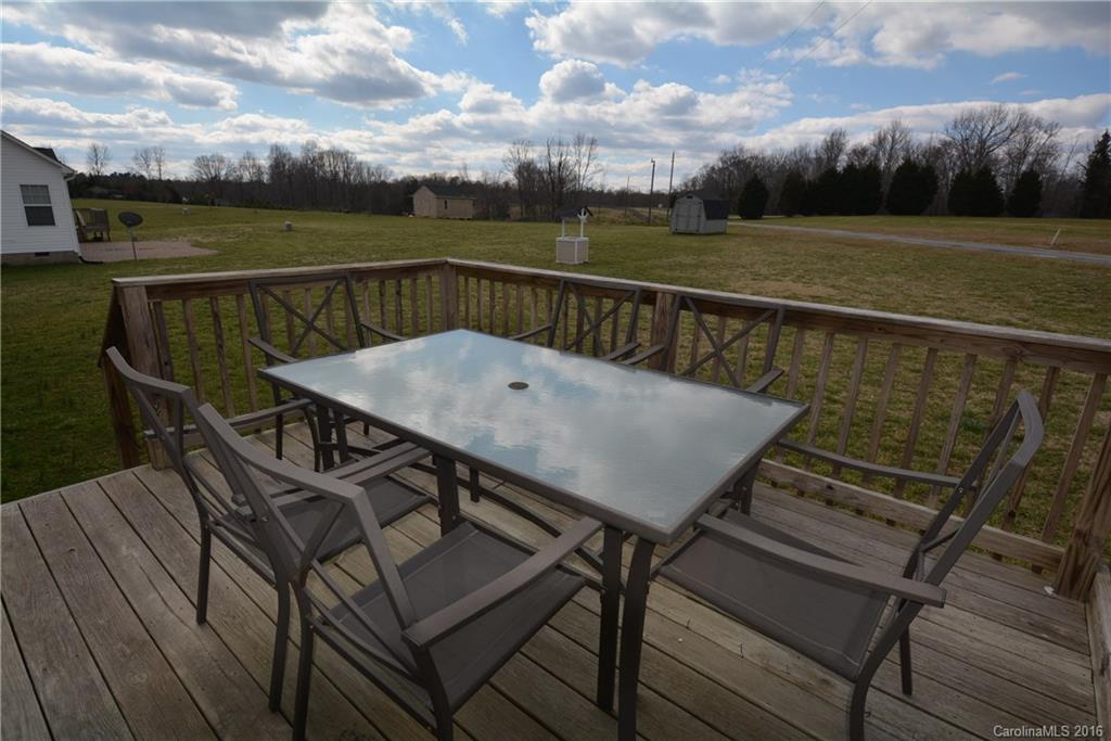 214 Pendergrass Road York, SC 29745 - Photo 15 of 21 a view of a roof deck with table and chairs and wooden floor