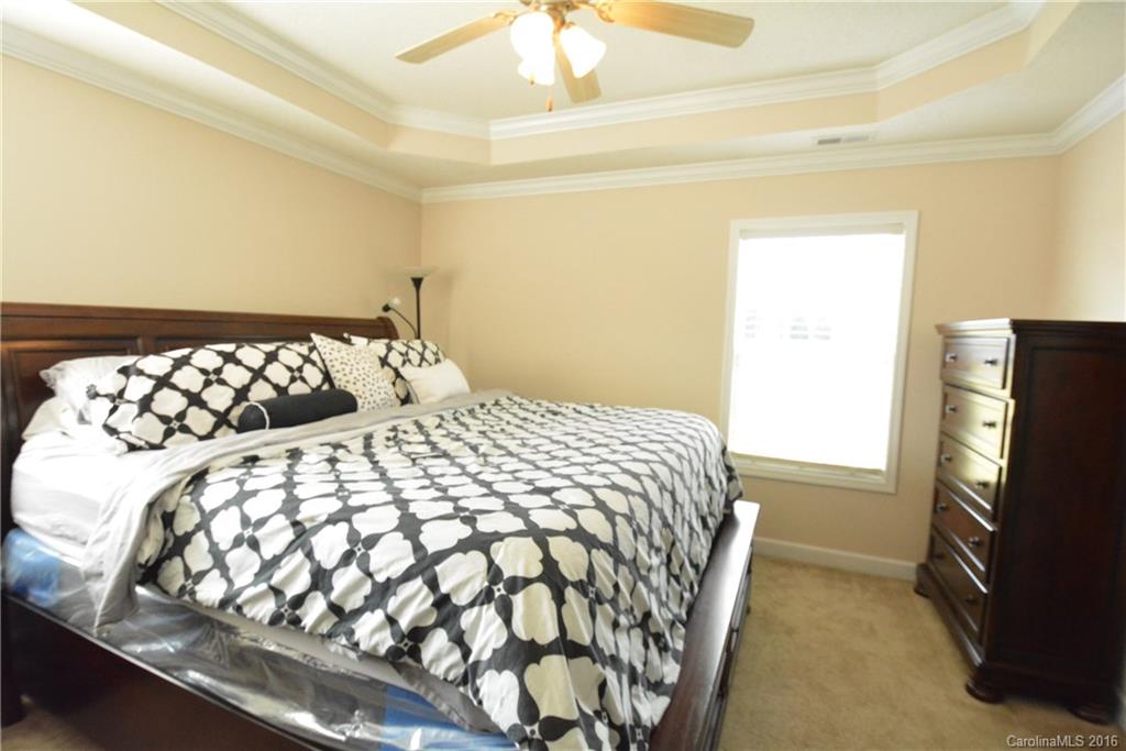 214 Pendergrass Road York, SC 29745 - Photo 8 of 21 a bedroom with a bed and a flat tv screen on the dresser